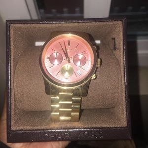 Gold michael Kors watch with pink detail